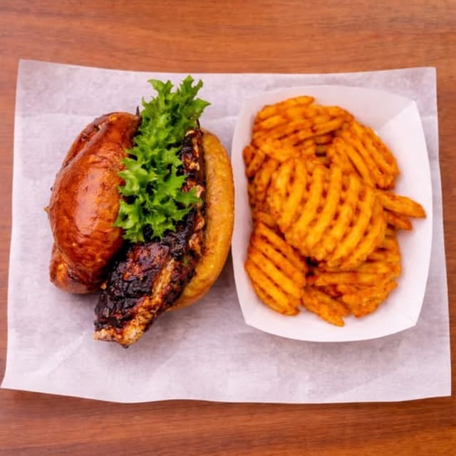 JERK CHICKEN SANDWICH WITH FRIES.