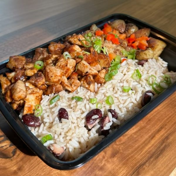 Stubbys' American cuisine: chicken and rice with red beans, garnished with green onions and red peppers.